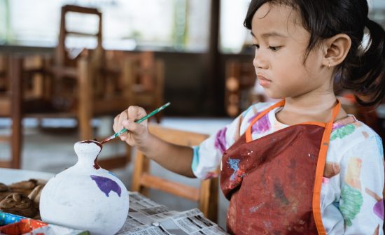 daughter learning about painting color in pottery workshop