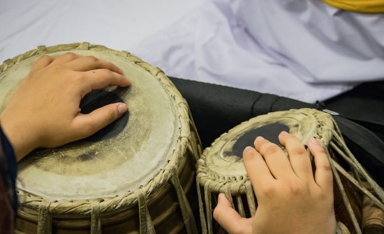 Hands,Performing,On,The,Double,Drum,Tabla,Instrument,Amidst,White